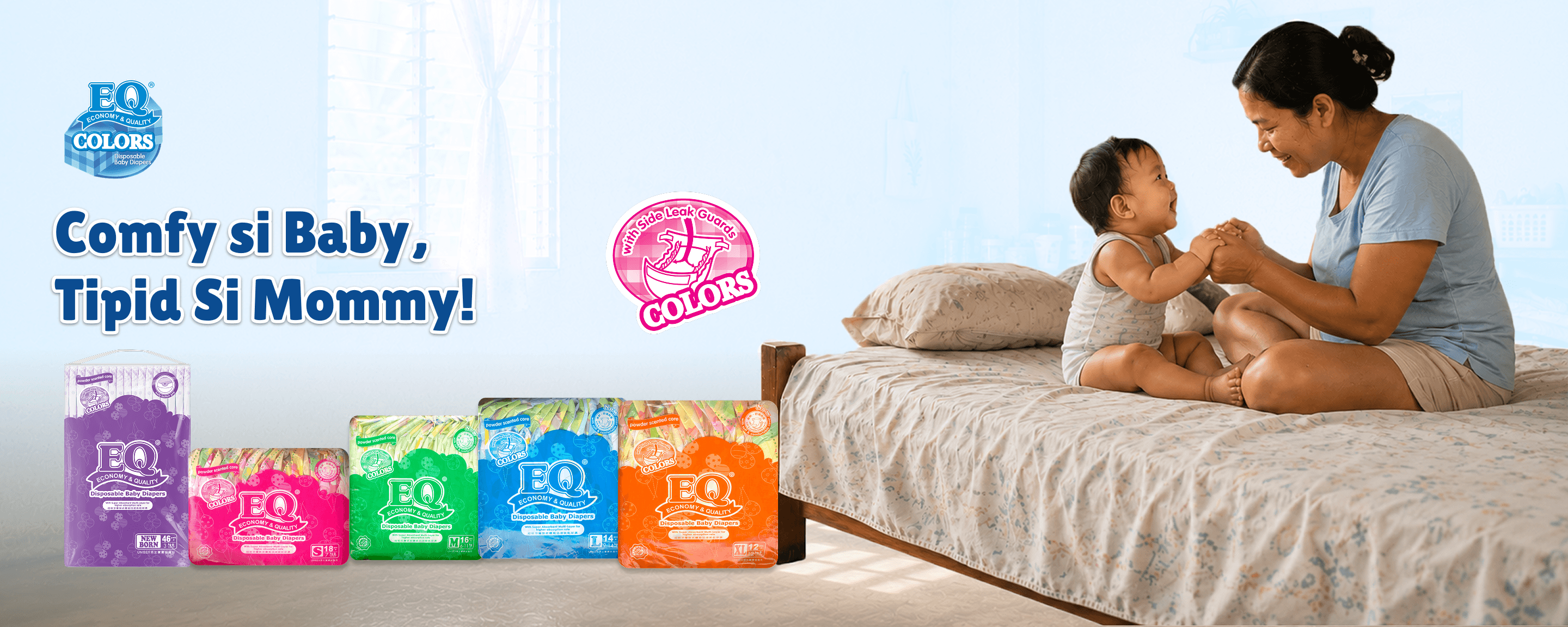 A mother and baby playing on a bed, alongside EQ Colors diaper packaging.