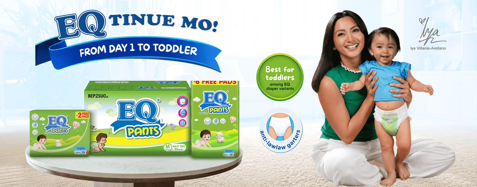 Iya Villania-Arellano smiling and holding a toddler wearing EQ diaper, alongside green EQ Pants packaging
