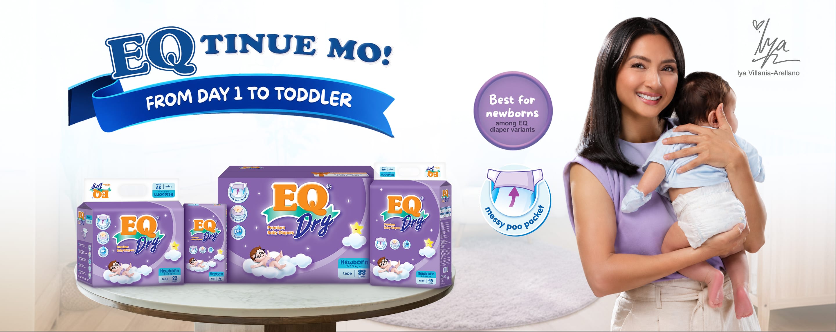 Iya Villania-Arellano holding a baby next to EQ Dry baby diaper packaging.